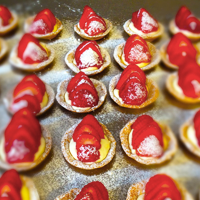 small sweet pasteries with strawberries on the top 